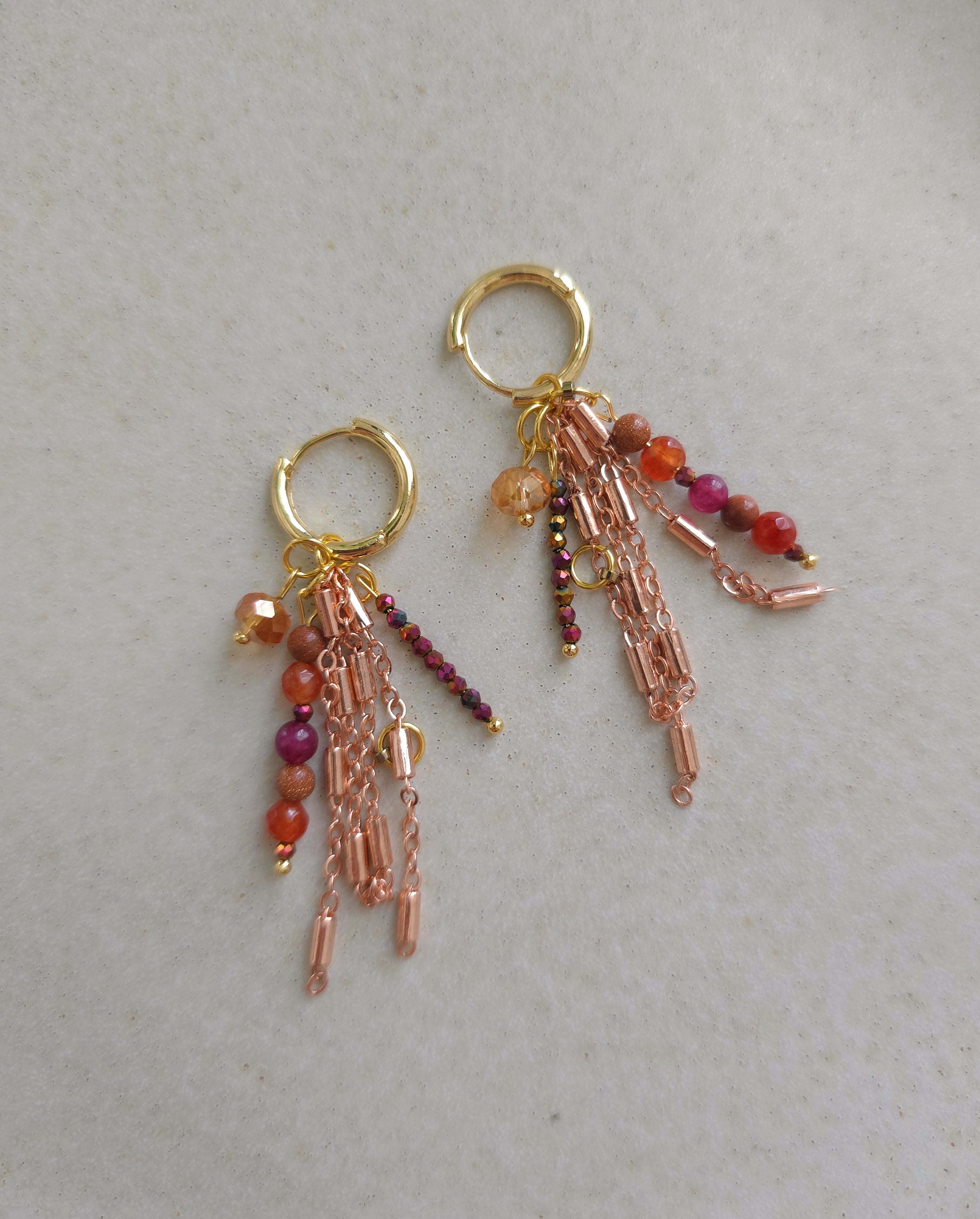 Golden statement earrings from chains and beads on Zara home plate