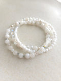 set of 3 white bracelets from different material beads